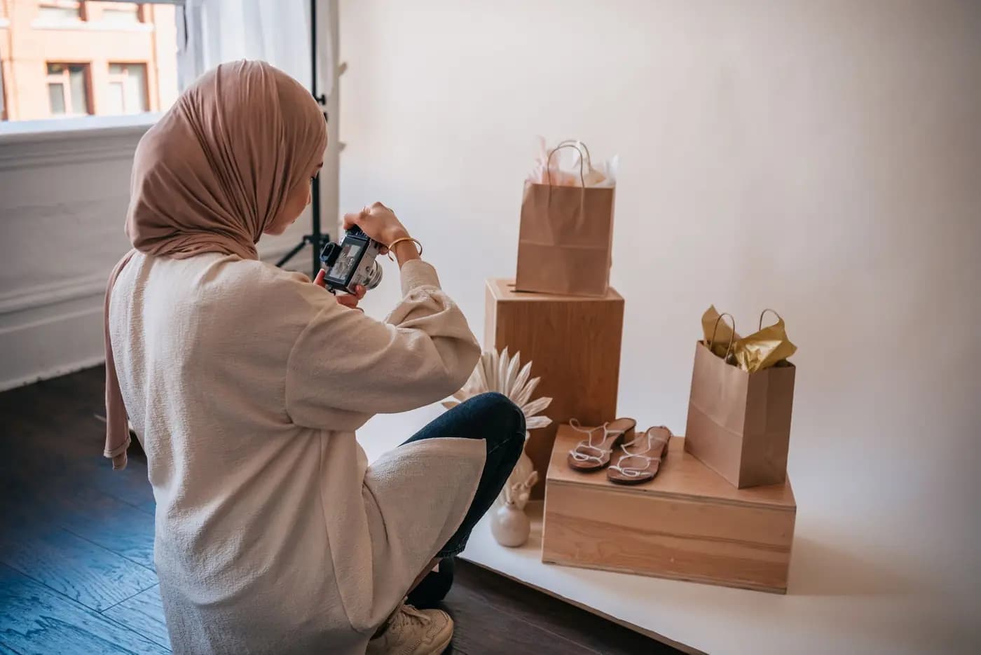 Woman photographing products for an online shop in a studio