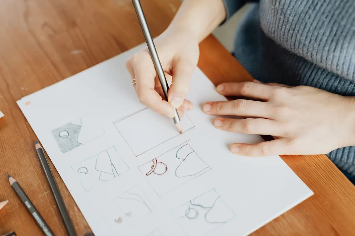 Designer sketching logo drafts in pencil